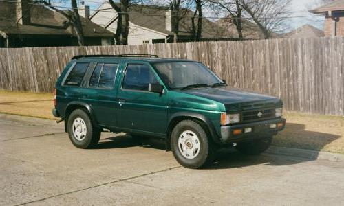 Older Nissan SUV parked in residential neighborhood